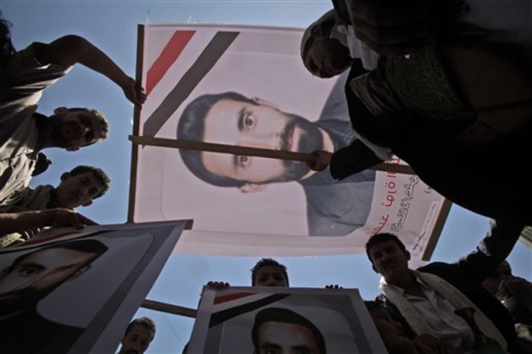 Anti-government protesters hold up a poster showing a demonstrator who was wounded in clashes with Yemeni forces and died Sunday. Protesters are rallying to demand the resignation of President Ali Abdullah Saleh, in Sanaa, Yemen.